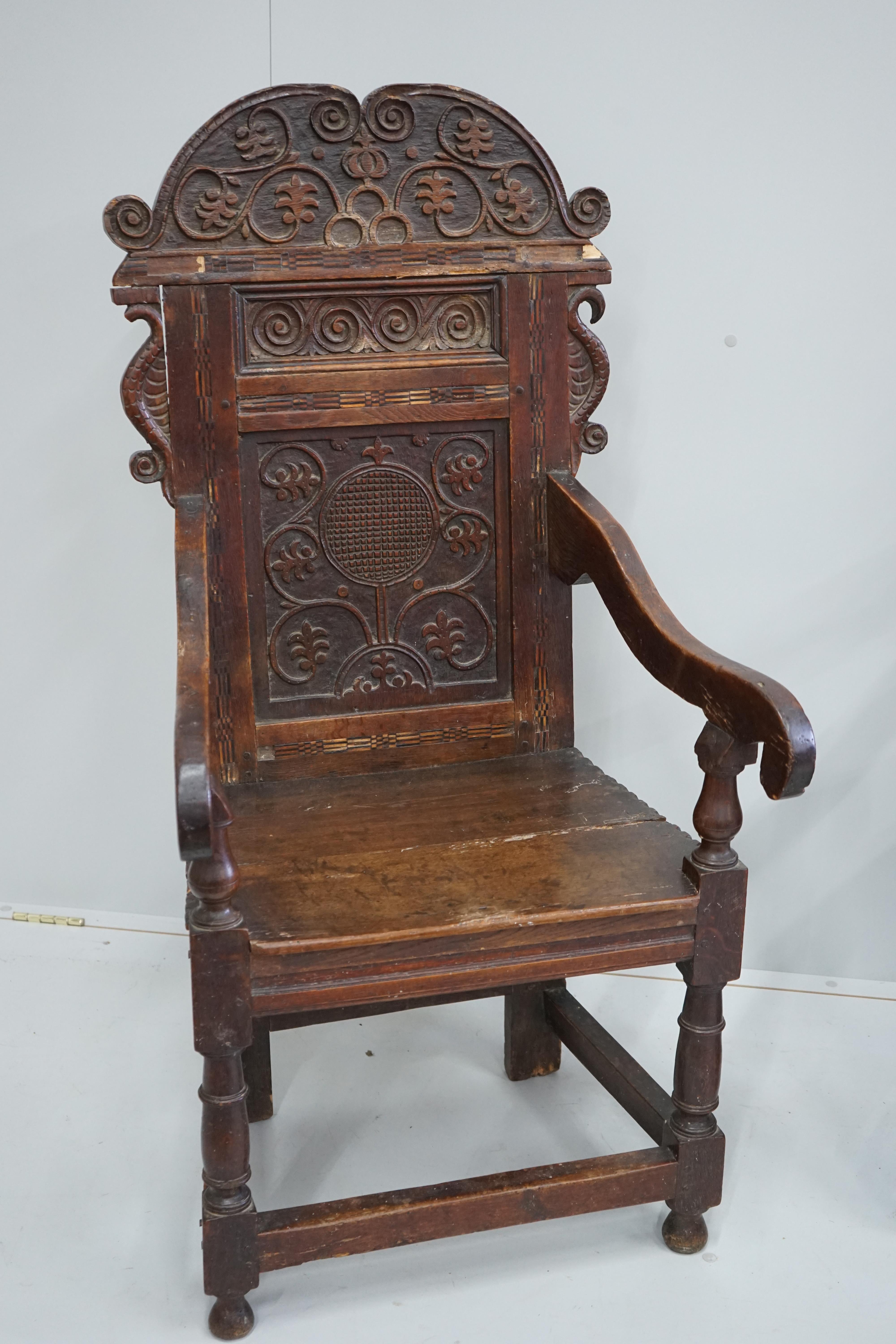 A pair of 17th century style inlaid panelled oak wainscot chairs, width 57cm, depth 40cm, height 121cm